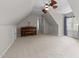 Spacious bonus room with carpet, piano, neutral walls, and cozy ceiling fans at 2118 Cloud Cover Ln, Raleigh, NC 27614