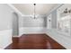 Formal dining room with hardwood floors, wainscoting, and a modern chandelier at 2118 Cloud Cover Ln, Raleigh, NC 27614