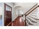 Bright foyer with hardwood floors, staircase, and arched doorway at 2118 Cloud Cover Ln, Raleigh, NC 27614