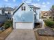 Exterior of home featuring a two-car garage and stone patio at 2118 Cloud Cover Ln, Raleigh, NC 27614