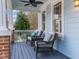 Comfortable seating on front porch with brick accents, views and ceiling fan at 2118 Cloud Cover Ln, Raleigh, NC 27614