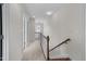 Bright hallway with neutral walls, carpet flooring, and a staircase at 2118 Cloud Cover Ln, Raleigh, NC 27614