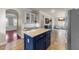 Open kitchen with central island with seating that leads to sitting area at 2118 Cloud Cover Ln, Raleigh, NC 27614