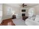 Cozy living room with a fireplace, plush seating, and hardwood floors at 2118 Cloud Cover Ln, Raleigh, NC 27614