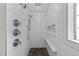 Modern shower with sleek tilework, multiple showerheads, and a convenient built-in bench at 2118 Cloud Cover Ln, Raleigh, NC 27614