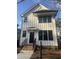 Charming two-story home with white siding, black trim, and brick stairs leading to the front door at 2214 Woodrow St, Durham, NC 27705