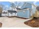 Backyard of a blue home with a concrete parking area and nice landscaping at 2218 Woodrow St, Durham, NC 27705