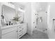 Bright bathroom featuring double sinks with marble countertops and modern fixtures at 2218 Woodrow St, Durham, NC 27705