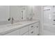 Bright bathroom featuring double sinks with white marble countertops and white cabinets at 2218 Woodrow St, Durham, NC 27705