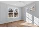 Bright bedroom with hardwood floors and natural light from two large windows at 2218 Woodrow St, Durham, NC 27705