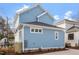 Charming two-story home with blue siding, a dark roof, and manicured landscaping at 2218 Woodrow St, Durham, NC 27705