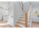 Hallway with hardwood stairs and open access to kitchen at 2218 Woodrow St, Durham, NC 27705