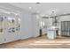 Bright open-concept kitchen with stainless steel appliances, island, and light hardwood floors at 2218 Woodrow St, Durham, NC 27705