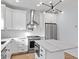 Gourmet kitchen with stainless steel appliances and stylish white cabinetry with marble countertops at 2218 Woodrow St, Durham, NC 27705