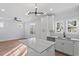 Modern kitchen featuring white cabinetry, a marble-topped island, and contemporary lighting at 2218 Woodrow St, Durham, NC 27705