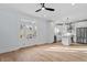 Bright open-concept kitchen with stainless steel appliances, island, and light hardwood floors at 2218 Woodrow St, Durham, NC 27705