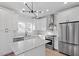 Gourmet kitchen with stainless steel appliances and stylish white cabinetry with marble countertops at 2218 Woodrow St, Durham, NC 27705
