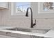 Sink with white marble backsplash and a view out the window at 2218 Woodrow St, Durham, NC 27705
