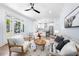 Bright, open-concept living area with hardwood floors, white walls, modern fan, and access to the kitchen at 2218 Woodrow St, Durham, NC 27705
