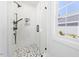 Modern bathroom with a glass-enclosed shower and stylish black and white tile flooring at 2218 Woodrow St, Durham, NC 27705
