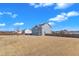 Wide angle of the backyard showing a wooden fence, a storage shed, plenty of open space, and exterior of the house at 2220 Stillness Pond Ln, Apex, NC 27539