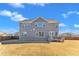 Back of the house with a backyard, patio, and a blue cloudy sky at 2220 Stillness Pond Ln, Apex, NC 27539