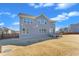 Exterior of home revealing large backyard, complimented by a wooden fence and a small deck off the back of the house at 2220 Stillness Pond Ln, Apex, NC 27539