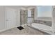 Modern bathroom with a seamless glass shower and separate tub with granite counters at 2220 Stillness Pond Ln, Apex, NC 27539