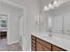 A bathroom with a white countertop, brown cabinets, mirror, and shower with curtain at 2220 Stillness Pond Ln, Apex, NC 27539