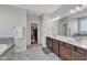 Bathroom featuring double sinks, granite countertops and a walk-in closet at 2220 Stillness Pond Ln, Apex, NC 27539