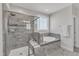Modern bathroom with a seamless glass shower and separate tub with granite counters at 2220 Stillness Pond Ln, Apex, NC 27539