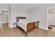 Neutral bedroom with hardwood floors and an ensuite bathroom at 2220 Stillness Pond Ln, Apex, NC 27539