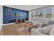 Inviting bonus room with a modern accent wall and plenty of natural light at 2220 Stillness Pond Ln, Apex, NC 27539