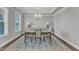 Bright dining room featuring hardwood floors, a stylish chandelier, and large windows at 2220 Stillness Pond Ln, Apex, NC 27539