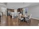 Dining Room with wood table and seating adjacent to open kitchen and living room at 2220 Stillness Pond Ln, Apex, NC 27539
