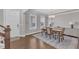 Elegant dining room with hardwood floors, chandelier, and ample natural light at 2220 Stillness Pond Ln, Apex, NC 27539