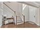 Spacious entryway features a staircase and an elegant console table at 2220 Stillness Pond Ln, Apex, NC 27539