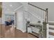 Welcoming foyer with hardwood floors, staircase, and stylish console table at 2220 Stillness Pond Ln, Apex, NC 27539