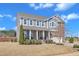 Charming two-story home featuring a landscaped yard, covered front porch, and attached two-car garage at 2220 Stillness Pond Ln, Apex, NC 27539