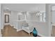 Upstairs landing featuring an elegant chandelier and a decorative bench at 2220 Stillness Pond Ln, Apex, NC 27539