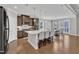 Modern kitchen with a large island, stainless steel appliances, and an adjacent dining area at 2220 Stillness Pond Ln, Apex, NC 27539