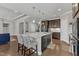 Open kitchen with granite counters, stainless appliances, brown cabinets and island seating at 2220 Stillness Pond Ln, Apex, NC 27539