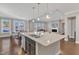 Kitchen island with granite counters, stainless appliances, and stainless sink at 2220 Stillness Pond Ln, Apex, NC 27539
