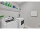 Laundry room with a washer and dryer, shelf and cleaning detergents at 2220 Stillness Pond Ln, Apex, NC 27539