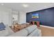 Comfortable living room with a modern accent wall and wood floors at 2220 Stillness Pond Ln, Apex, NC 27539