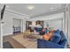 Open floor plan living room with fireplace, kitchen and dining room at 2220 Stillness Pond Ln, Apex, NC 27539