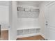 Well-organized mudroom featuring built-in storage, hooks and seating at 2220 Stillness Pond Ln, Apex, NC 27539