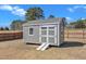 A well-maintained backyard storage shed with double doors and a ramp, set against a backdrop of mature trees at 2220 Stillness Pond Ln, Apex, NC 27539