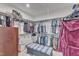 Large walk-in closet with plenty of storage, hanging racks and an ottoman at 2220 Stillness Pond Ln, Apex, NC 27539