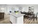 Kitchen island and dining area flowing into an open-concept living space with lots of light at 225 Elyse Overlook Loop, Sanford, NC 27332